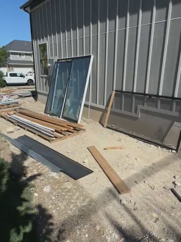 8 foot tall by 8 foot wide sliding patio door that has black exterior