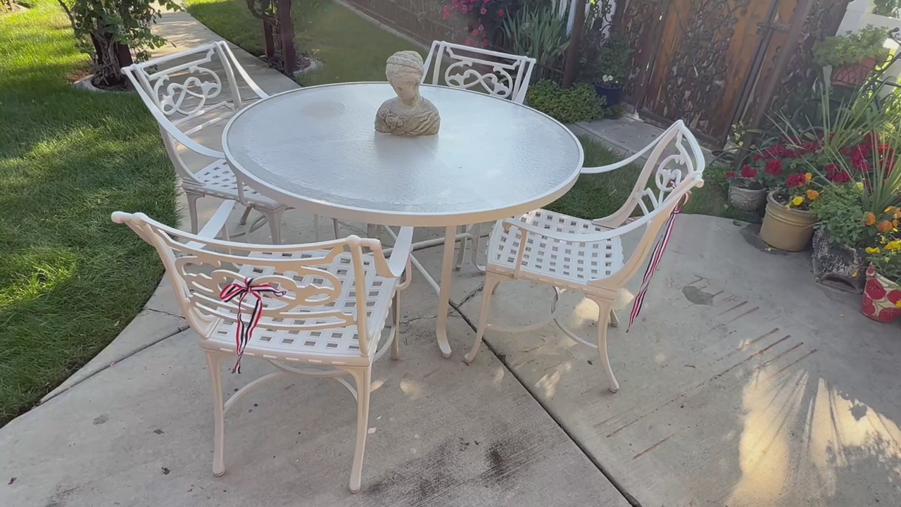 Vintage patio set with 4 chairs very heavy thick metal 48” W it does not include decor or statue.